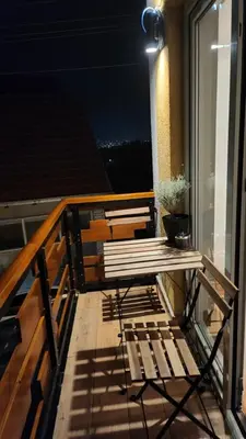 a balcony with a bench and a table on a balcony at Gore Dole in Donji Matejevac