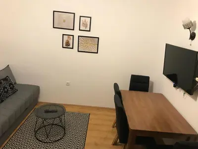 a living room with a table and a couch at Planinski Raj - Bela Reka Gondola in Brzeće
