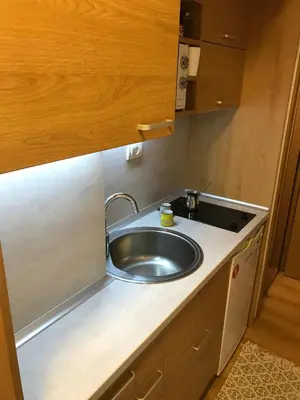 a kitchen counter with a sink in a room at Planinski Raj - Bela Reka Gondola in Brzeće