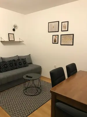 a living room with a couch and a table at Planinski Raj - Bela Reka Gondola in Brzeće