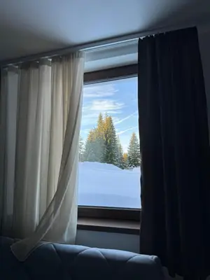 a window with a view of a snow covered yard at ZIMSKI Apartmani in Kopaonik