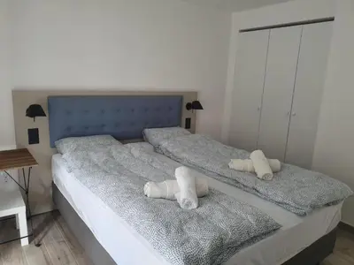 a bedroom with two beds with white pillows on them at Vila Lela in Vrnjačka Banja