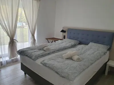a bed with two pillows on it in a bedroom at Vila Lela in Vrnjačka Banja