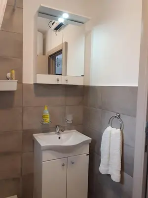 a bathroom with a sink and a mirror at Vila Lela in Vrnjačka Banja