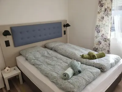 a bedroom with two beds with towels on them at Vila Lela in Vrnjačka Banja