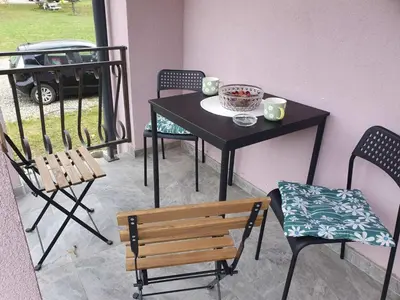 a table and chairs and a table and a table and chairs at Vila Lela in Vrnjačka Banja