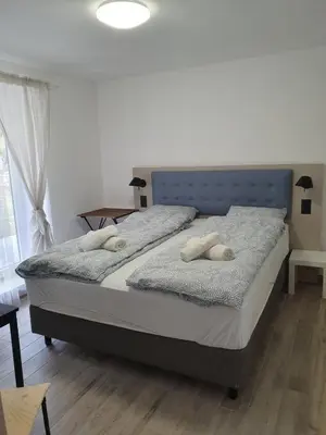 a bedroom with a bed with two towels on it at Vila Lela in Vrnjačka Banja
