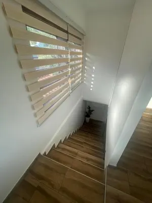 a staircase with a window and a wooden floor at Temački konaci in Pirot