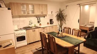 a kitchen and dining room with a table and chairs at Temački konaci in Pirot
