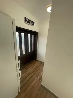 an empty room with a door and wooden floors at Temački konaci in Pirot