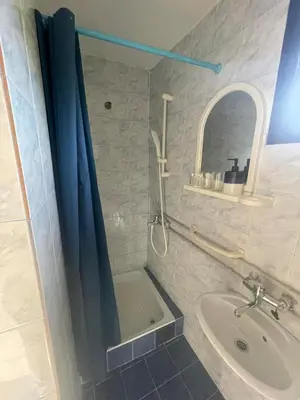 a bathroom with a shower curtain and a sink at Temački konaci in Pirot