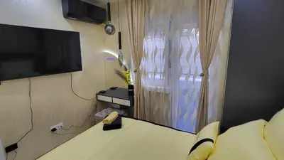 a room with a bed and a tv and a window at Apartman POSEJDON DELUXE 2 in Vrnjačka Banja