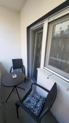 a small room with two chairs and a table and a window at Apartman POSEJDON DELUXE 2 in Vrnjačka Banja