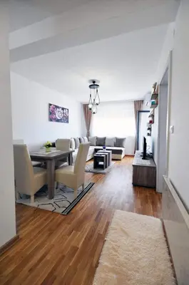 a living room with a table and a couch at Apartman Filipović Vrnjačka Banja in Vrnjačka Banja
