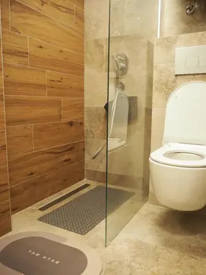 a bathroom with a toilet and a glass shower at Apartman Duda in Kopaonik