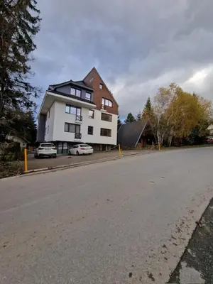 a large house on the side of a street at Apartman Duda in Kopaonik