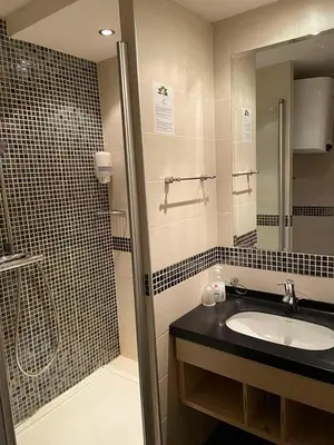 a bathroom with a sink and a shower at Apartmani Haski Konaci in Kopaonik