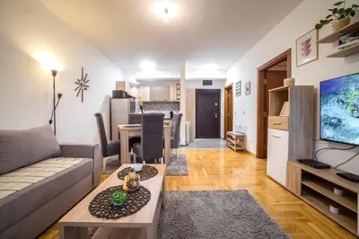 a living room with a couch and a table at Lux Apartmani Rakić in Pirot