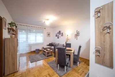 a living room with a couch and a table at Lux Apartmani Rakić in Pirot