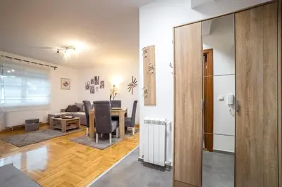 a living room with a couch and a table at Lux Apartmani Rakić in Pirot