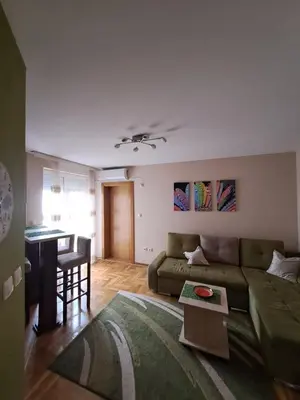 a living room with a couch and a table at MAŠA Apartman Vrnjacka Banja in Vrnjačka Banja