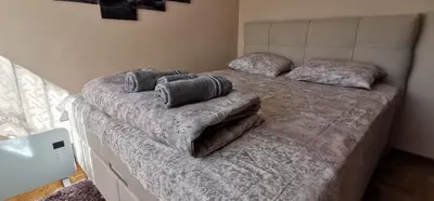 a bed with pillows on it in a bedroom at MAŠA Apartman Vrnjacka Banja in Vrnjačka Banja