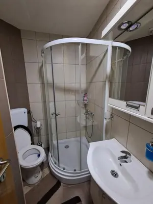 a bathroom with a shower and a toilet and a sink at MAŠA Apartman Vrnjacka Banja in Vrnjačka Banja