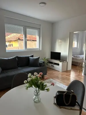 a living room with a table and a couch at House Inn 2 in Pirot