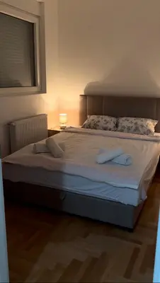a bedroom with a large bed with two pillows at House Inn 2 in Pirot