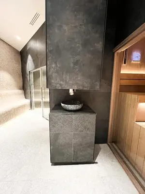 a bathroom with a fountain in the middle of a room at Woodside 007 in Kopaonik