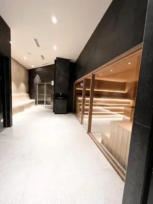 a dressing room with black walls and white tile floors at Woodside 007 in Kopaonik