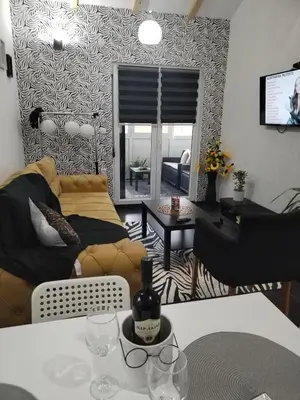 a living room with a couch and a table at MERLIN KUĆa in Vrnjačka Banja