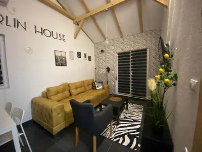 a living room with a couch and a table at MERLIN KUĆa in Vrnjačka Banja