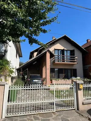 a white fence in front of a house at InterInn Luxury Villa in Paraćin
