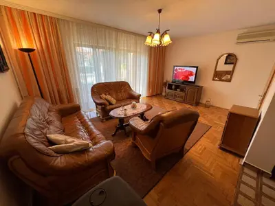 a living room with leather furniture and a tv at InterInn Luxury Villa in Paraćin