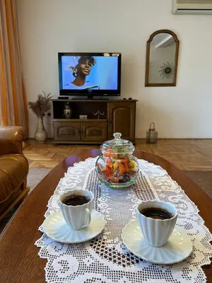 a coffee table with two cups of coffee on it at InterInn Luxury Villa in Paraćin