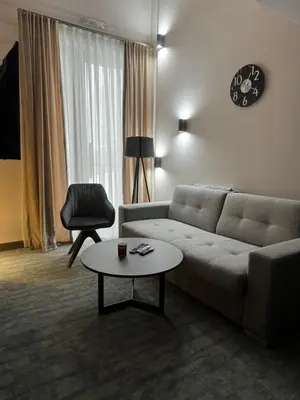 a living room with a couch and a table at Woodside Kopaonik Duplex 003 in Kopaonik