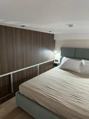 a bedroom with a bed and a wooden wall at Woodside Kopaonik Duplex 003 in Kopaonik