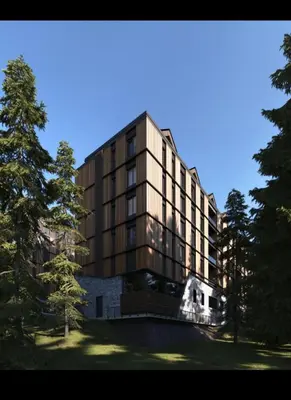 a large building with trees in front of it at Woodside Kopaonik Duplex 003 in Kopaonik