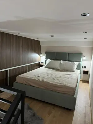 a bedroom with a large bed and wooden walls at Woodside Kopaonik Duplex 003 in Kopaonik