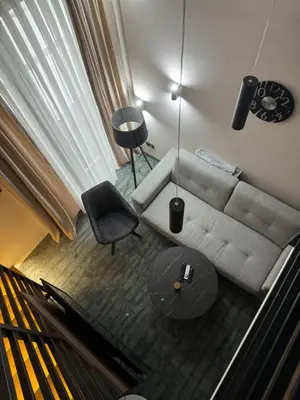 a living room with a couch and a table and a piano at Woodside Kopaonik Duplex 003 in Kopaonik