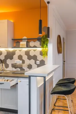 a kitchen with a counter and two stools at Apartman Nika in Pirot