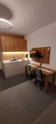 a kitchen with a table and chairs in a room at PAHULJA Vila Bela Reka Kopaonik Brzeće in Brzeće