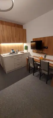 a kitchen with a table and chairs in a room at PAHULJA Vila Bela Reka Kopaonik Brzeće in Brzeće
