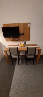 a wooden table with two chairs and a table with a mirror at PAHULJA Vila Bela Reka Kopaonik Brzeće in Brzeće