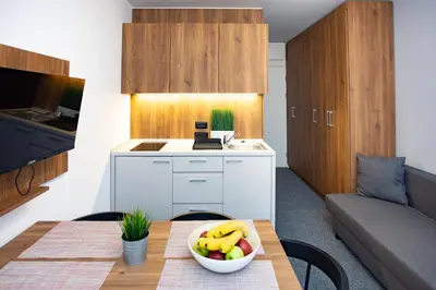 a kitchen with a table with a bowl of fruit on it at Ramonda apartman Vila Bela Reka 50m from Gondola - free parking acces in Brzeće