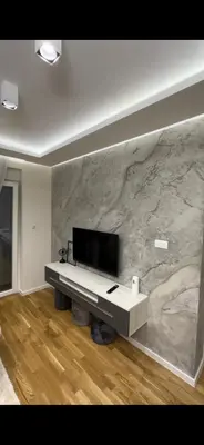 a living room with a piano and a stone wall at Magic Apartments Sokobanja in Soko Banja