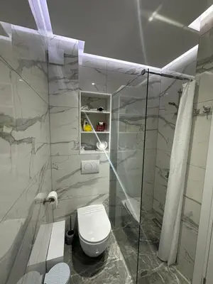 a bathroom with a toilet and a glass shower at Magic Apartments Sokobanja in Soko Banja