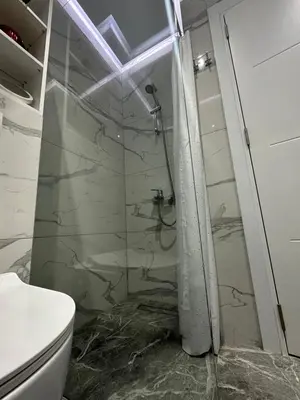 a bathroom with a shower and a toilet at Magic Apartments Sokobanja in Soko Banja