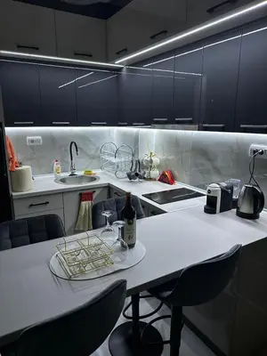 a kitchen with a table with a bottle of wine on it at Magic Apartments Sokobanja in Soko Banja